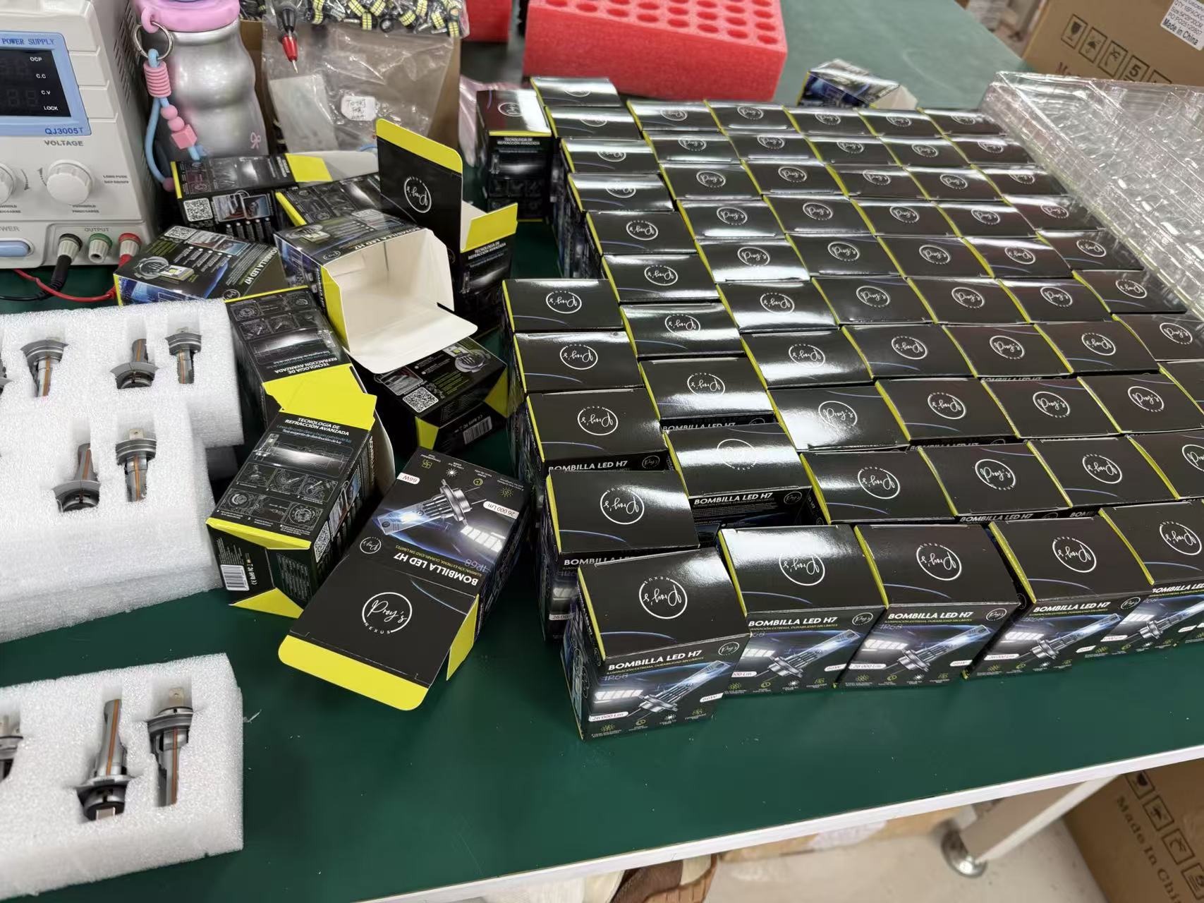 Color boxes of LED headlight bulbs being packed on the factory table